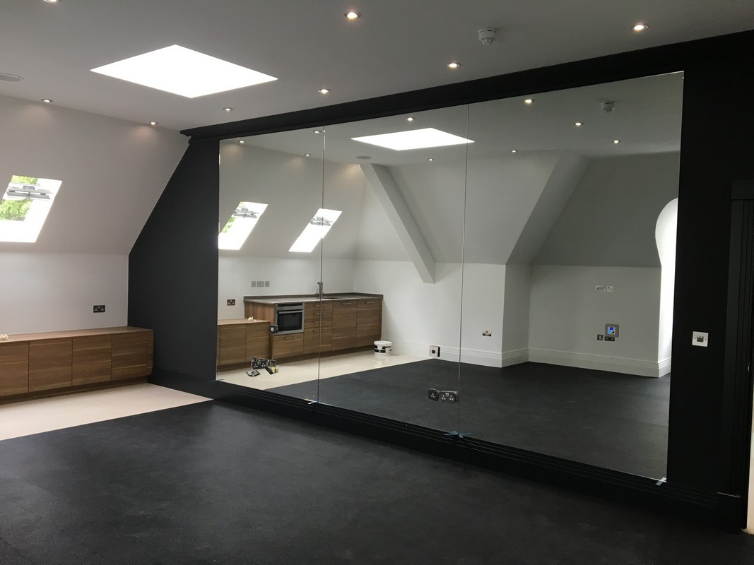 Frameless glass wall dividing loft conversion in Moorgate